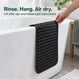 Bath mat hanging over the tub rim to dry